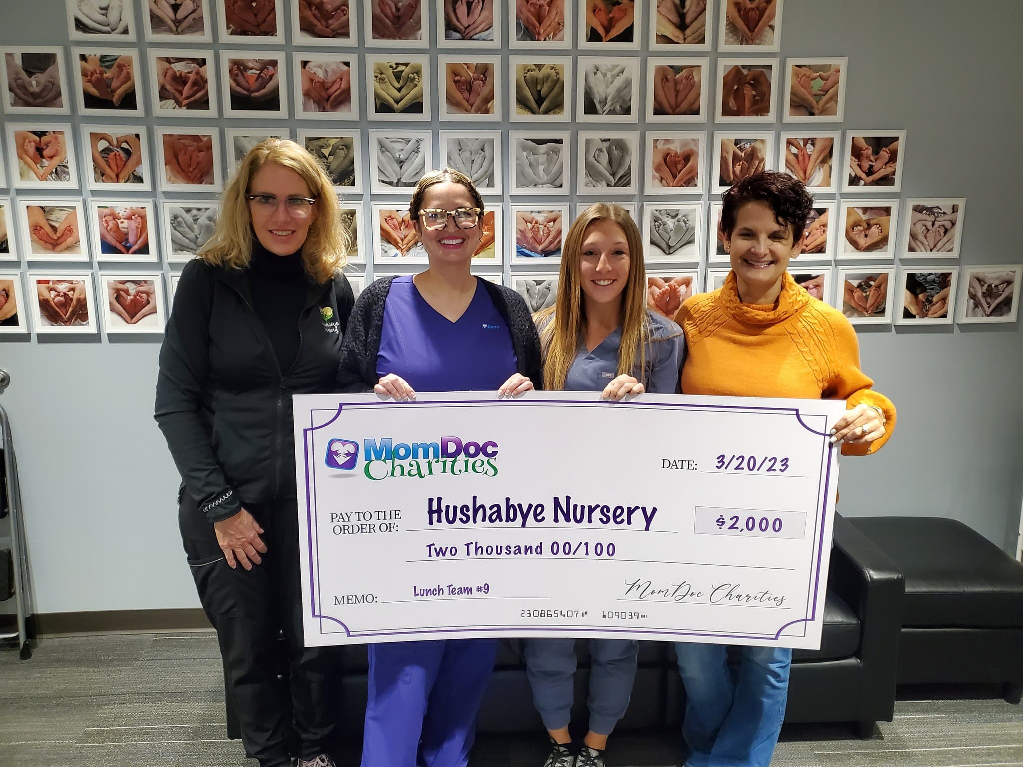 MomDoc Charities presenting a $2,000 donation check to Hushabye Nursery